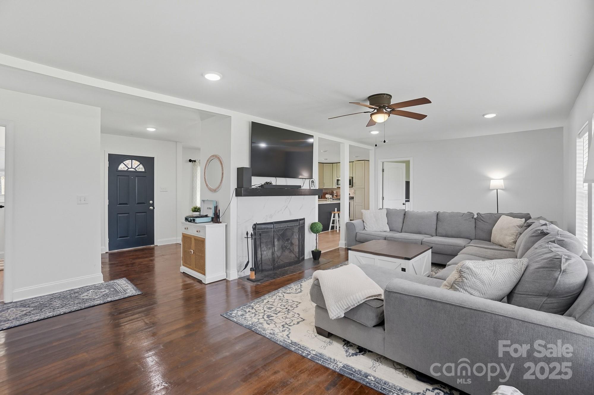 813 Bethlehem Road Kings Mountain, NC 28086 - Photo 17 of 39 a living room with furniture a fireplace and a flat screen tv