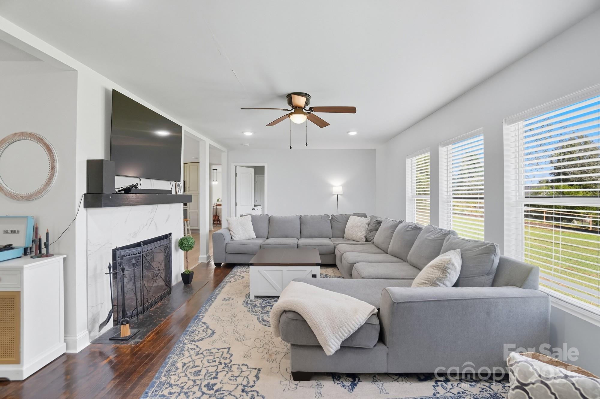813 Bethlehem Road Kings Mountain, NC 28086 - Photo 18 of 39 a living room with furniture a fireplace and a flat screen tv
