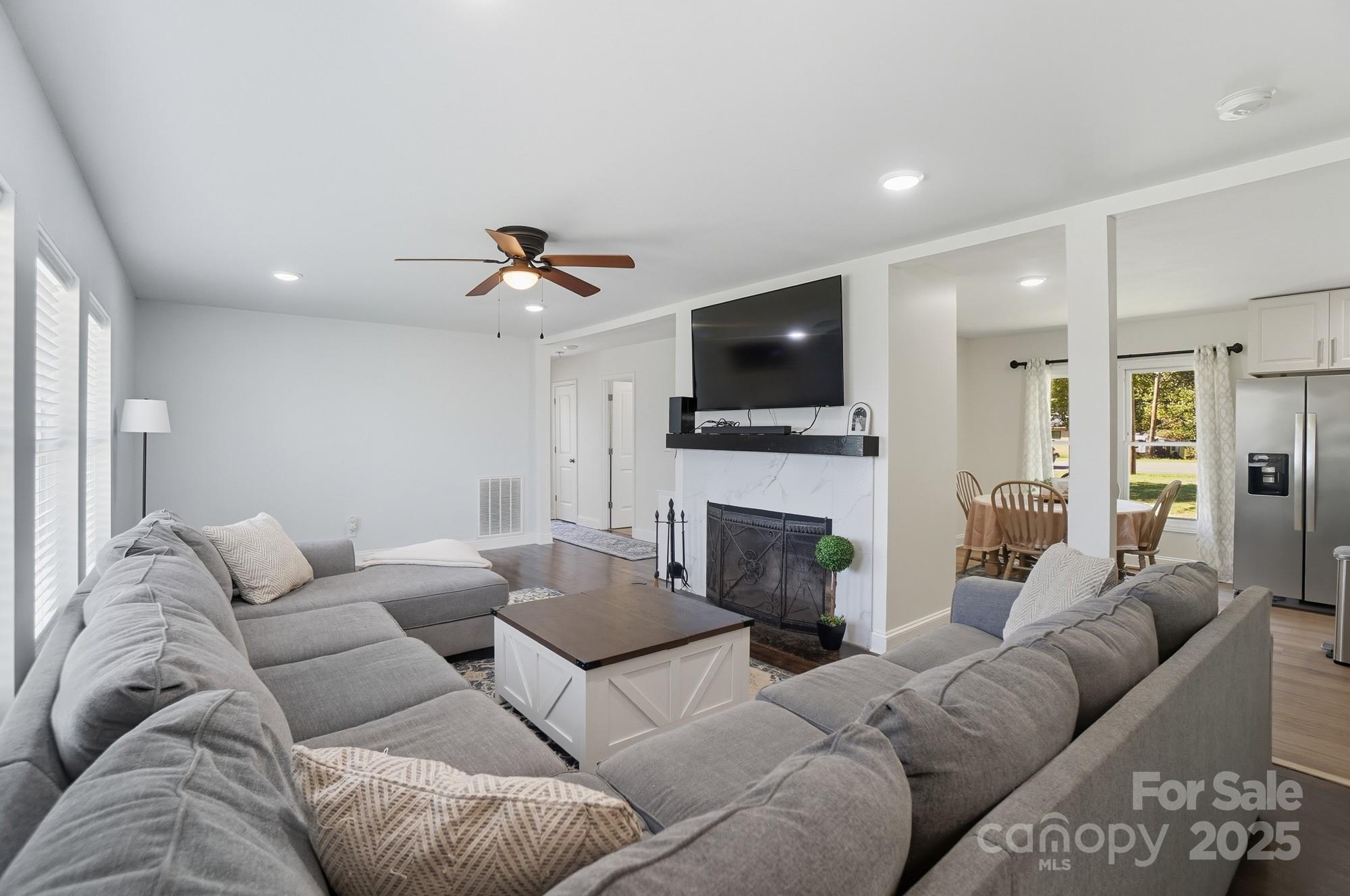 813 Bethlehem Road Kings Mountain, NC 28086 - Photo 20 of 39 a living room with furniture a fireplace and a flat screen tv