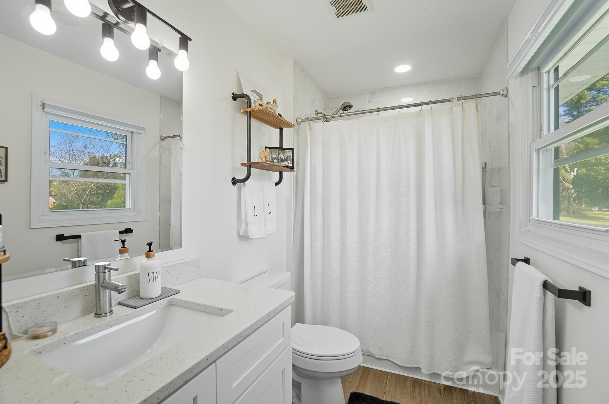 813 Bethlehem Road Kings Mountain, NC 28086 - Photo 22 of 39 a bathroom with a sink vanity mirror and toilet