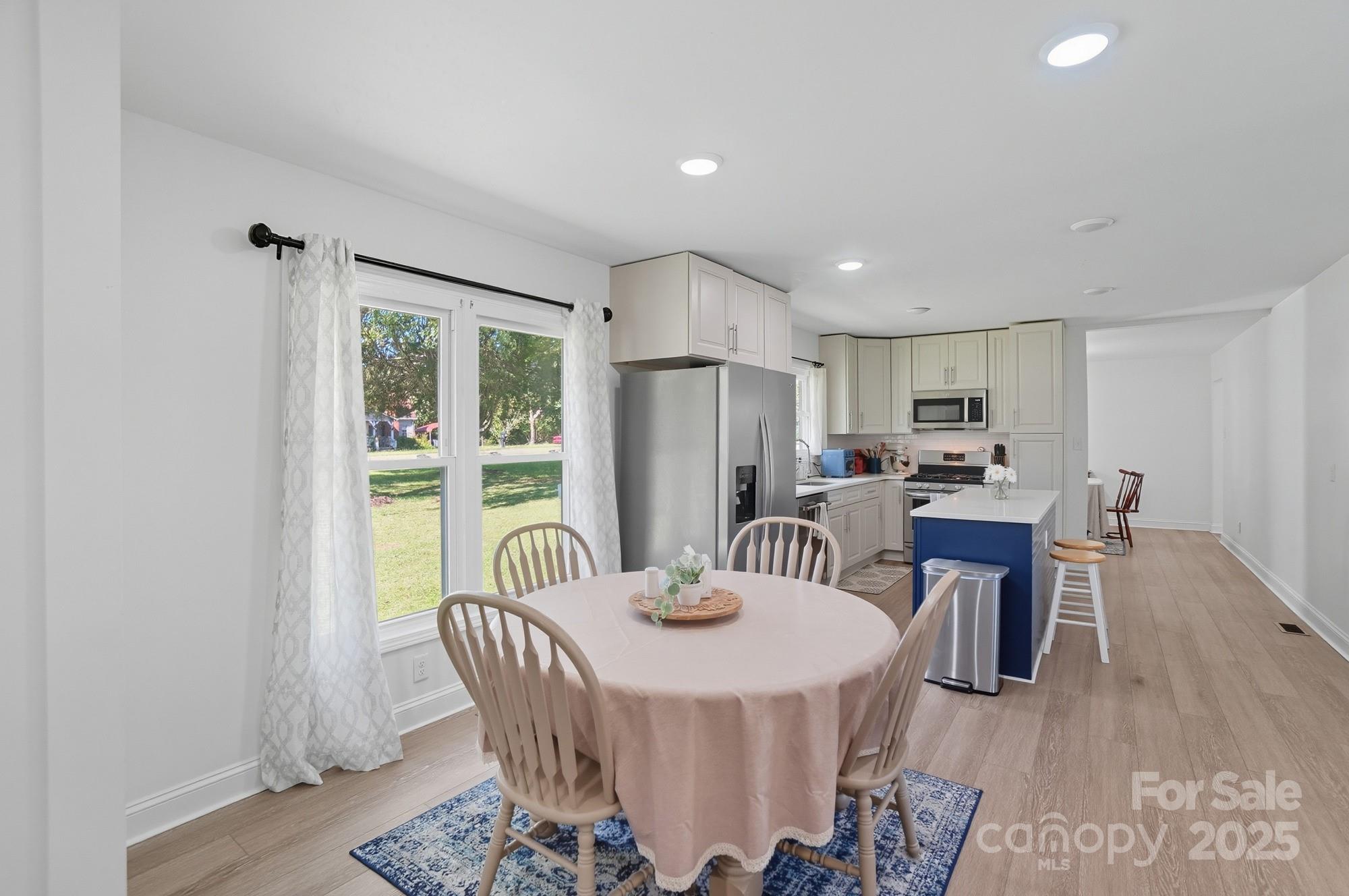 813 Bethlehem Road Kings Mountain, NC 28086 - Photo 6 of 39 a kitchen with granite countertop a dining table chairs and a refrigerator