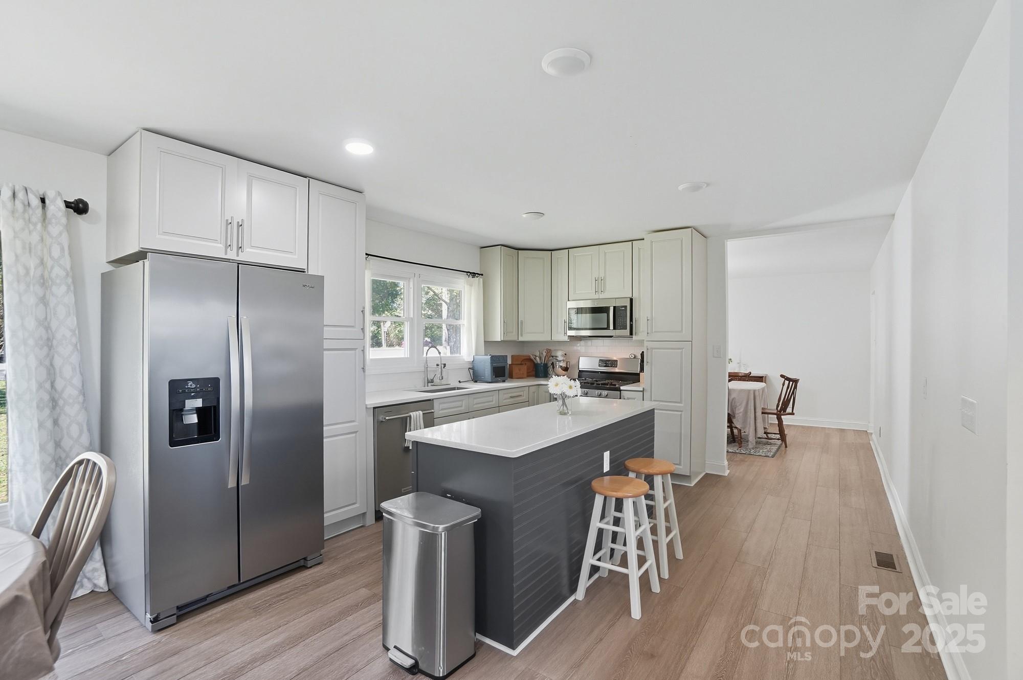 813 Bethlehem Road Kings Mountain, NC 28086 - Photo 8 of 39 a kitchen with refrigerator and chairs