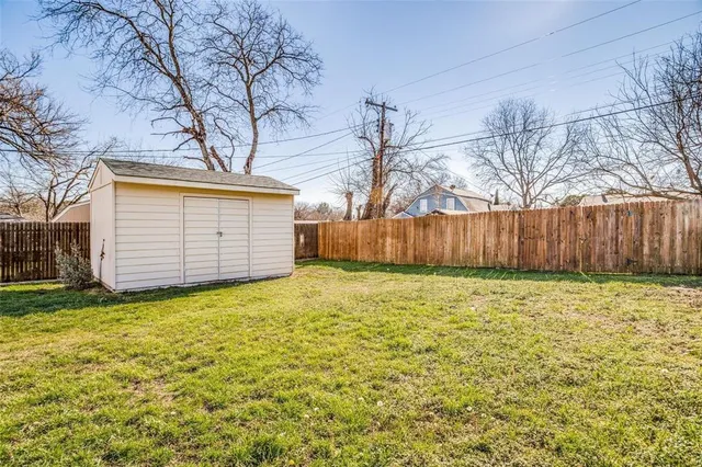 a view of a backyard with large tree