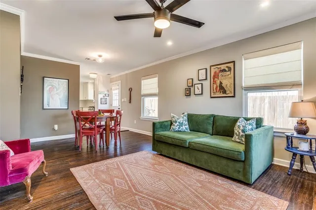 a living room with furniture a rug and a window