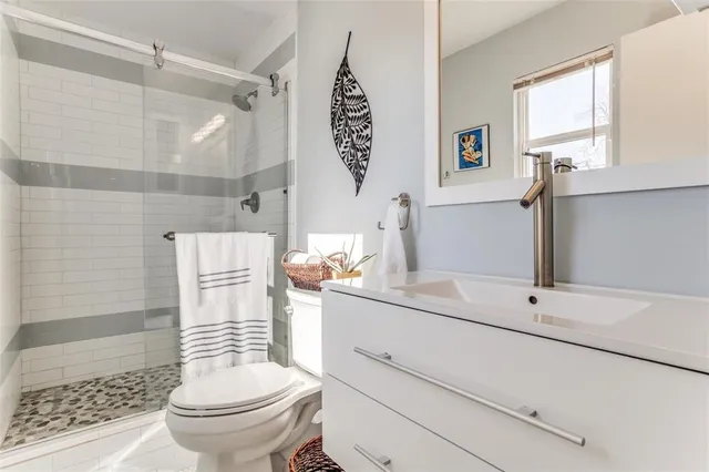 a bathroom with a sink toilet and shower