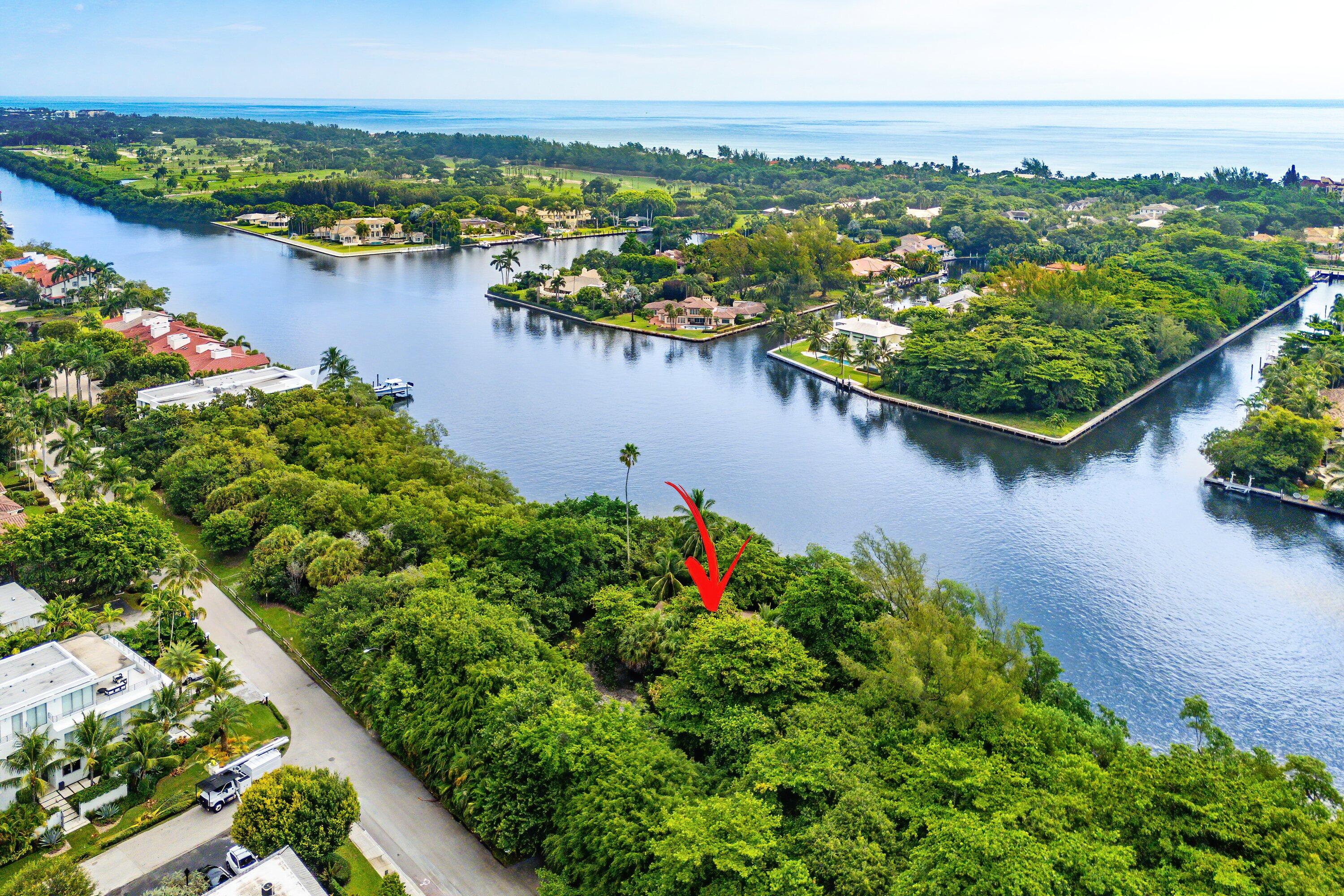 an aerial view of lake and residential houses with outdoor space