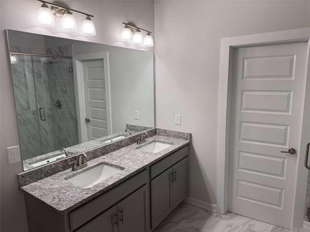 2530 Harbor Ridge Gainesville, GA 30507 - Photo 31 of 44 a bathroom with a granite countertop sink and a mirror