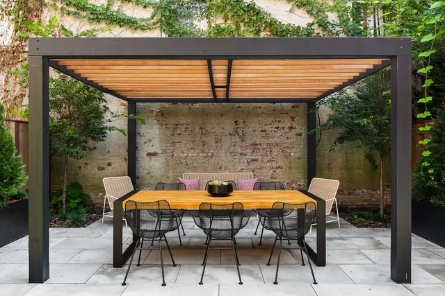 a backyard of a house with table and chairs