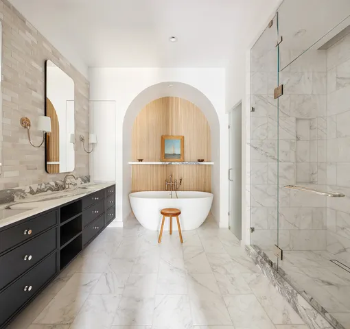 a large spacious bathroom with a tub sink shower and mirror