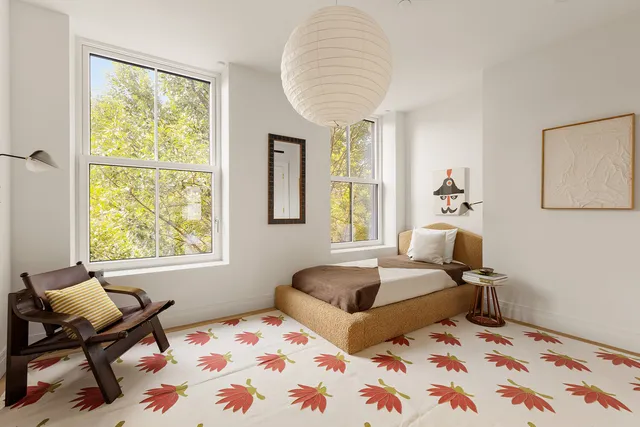 a bedroom with two beds and a window