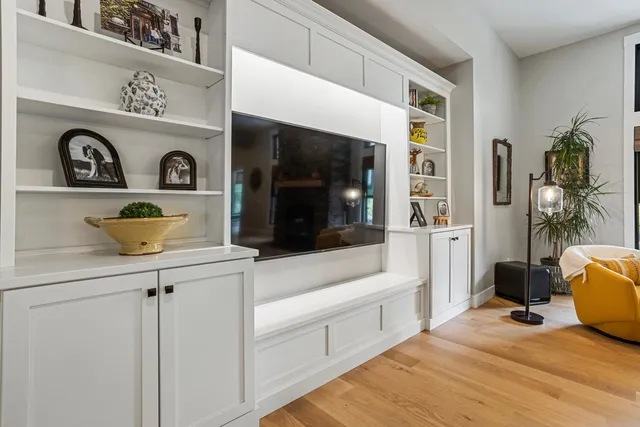 a kitchen with stainless steel appliances white cabinets and a stove top oven