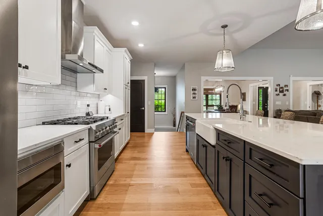 a spacious bathroom with a granite countertop sink and a mirror