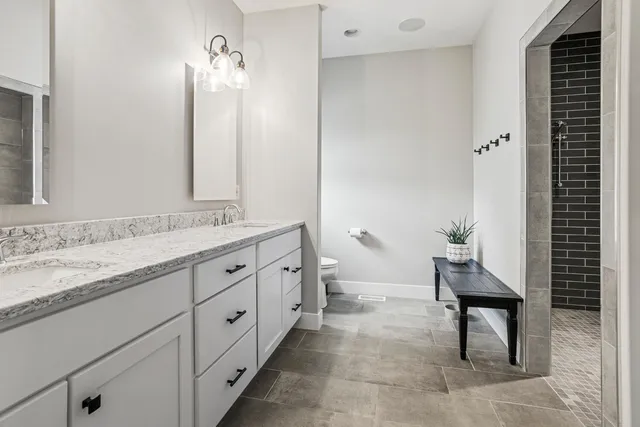 a bedroom with a bed and a chair in it