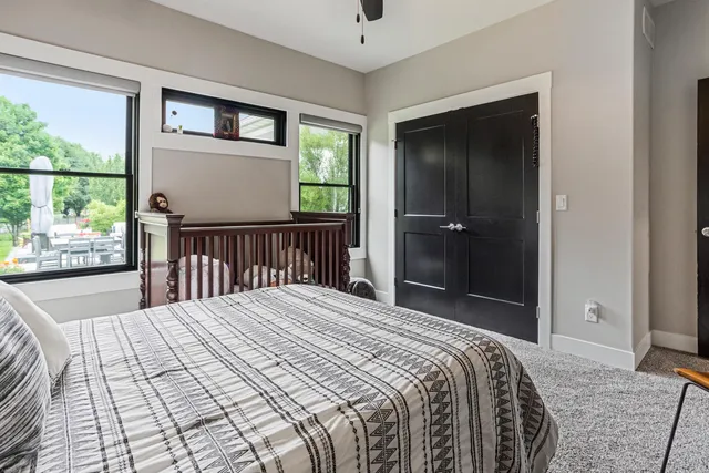 a living room with furniture and a floor to ceiling window