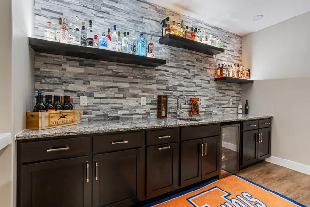 a front view of a house with a yard and a garden