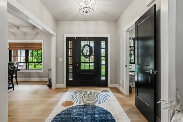 a living room with furniture a fireplace and a large window
