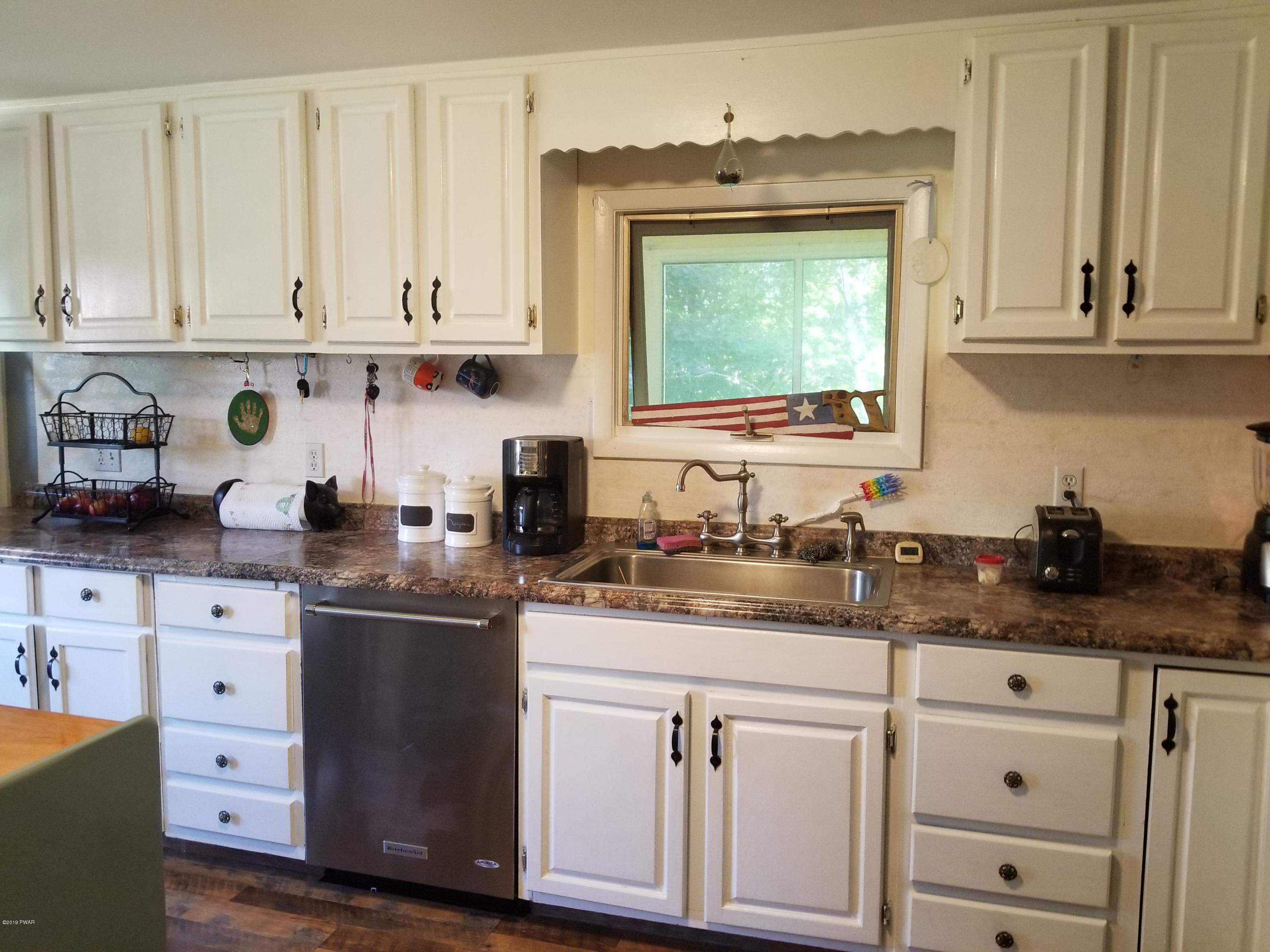 144 Mid Valley Road Lake Ariel, PA 18436 - Photo 10 of 55 a kitchen with granite countertop white cabinets and white appliances