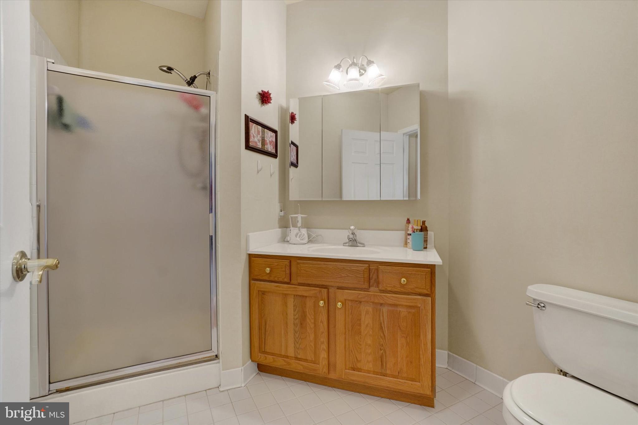 1010 Crest Way, Unit 304 York, PA 17403 - Photo 21 of 24 a bathroom with a granite countertop sink toilet and shower