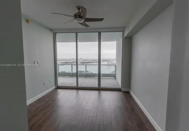 a view of room with wooden floor and fan