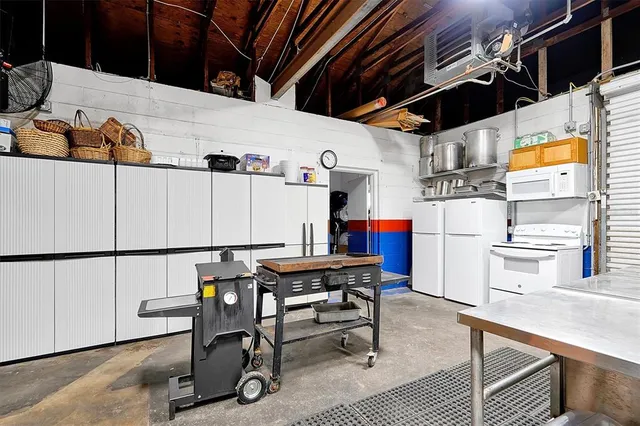 a front view of a house with a yard and potted plants