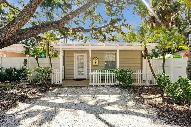 a kitchen with granite countertop a white stove and cabinets
