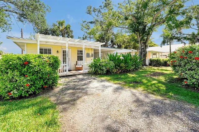 a bedroom with 2 bed and a chandelier