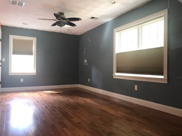 11 Woodbury Road Billerica, MA 01821 - Photo 13 of 27 a view of an empty room with wooden floor and a window