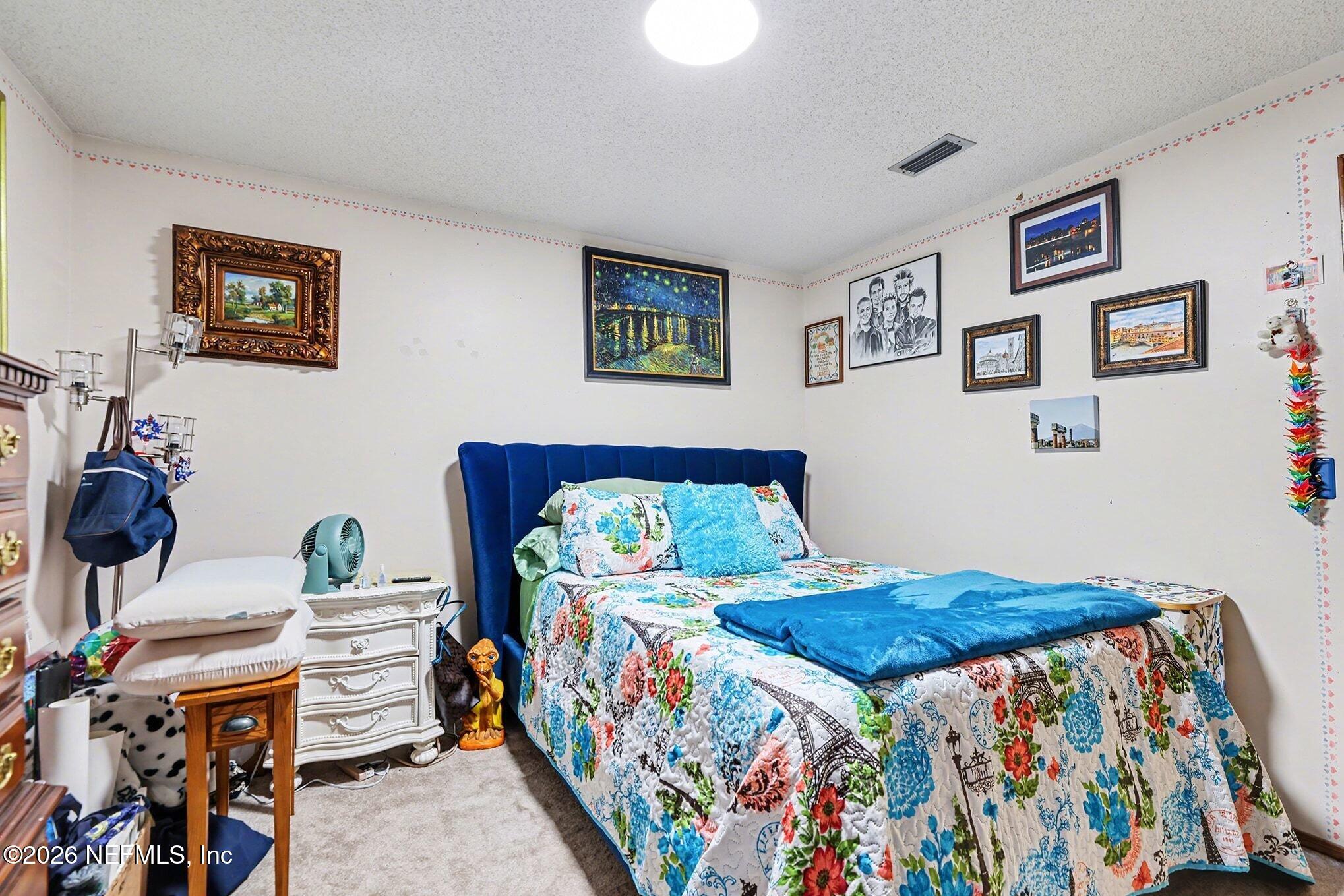 2551 Ridgecrest Avenue Orange Park, FL 32065 - Photo 18 of 28 a bedroom with a bed and dresser