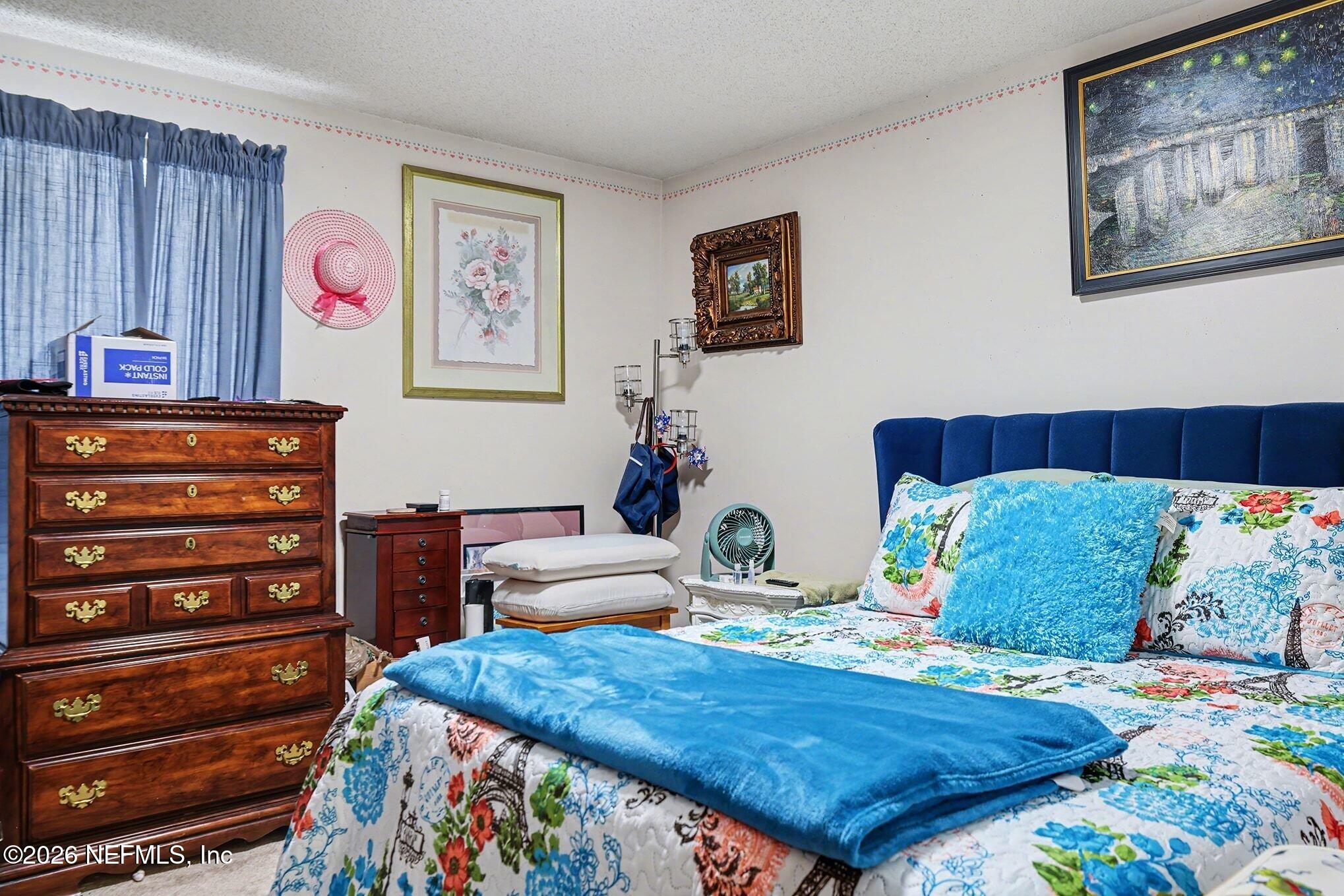 2551 Ridgecrest Avenue Orange Park, FL 32065 - Photo 19 of 28 a bed room with a bed and a chair