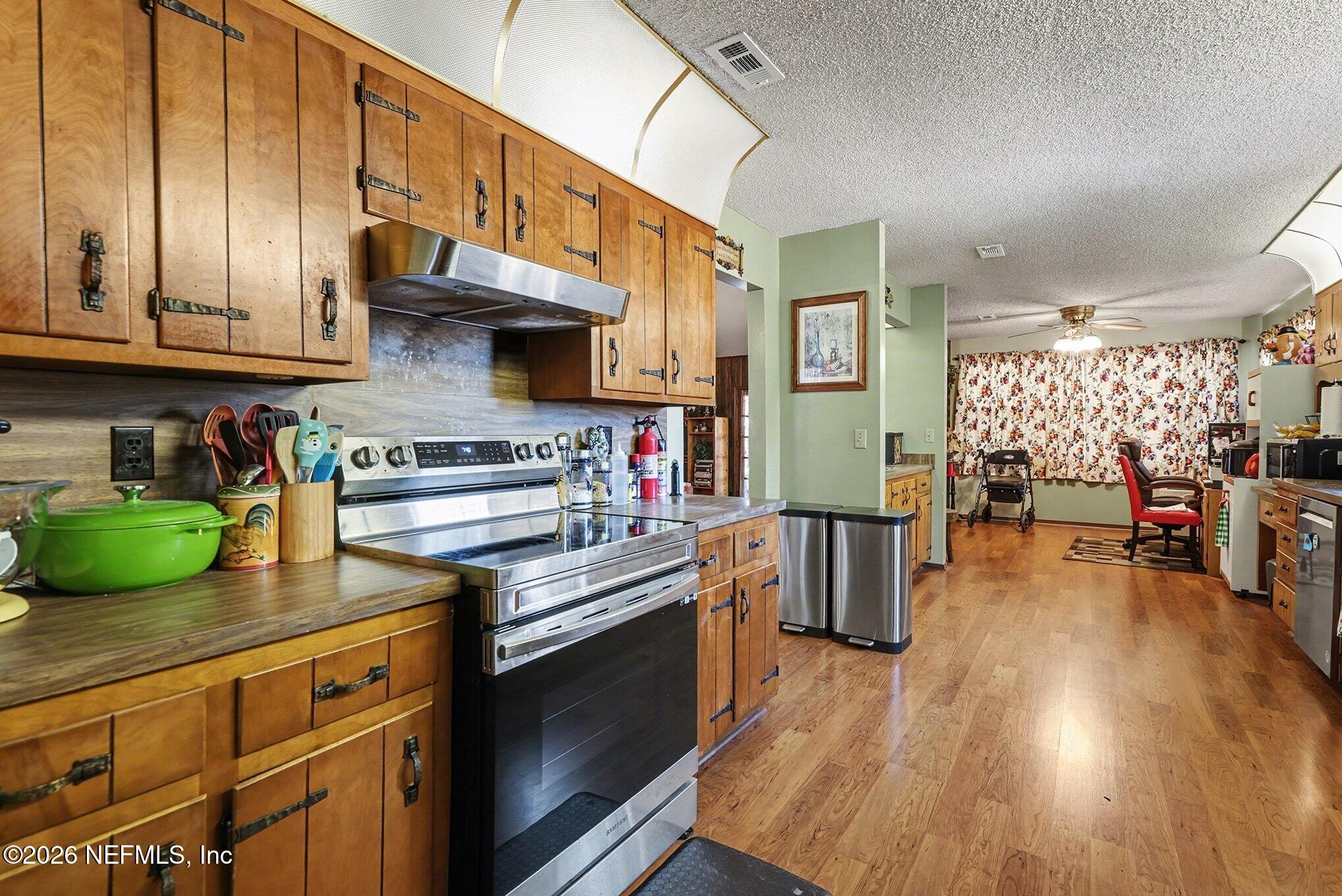 2551 Ridgecrest Avenue Orange Park, FL 32065 - Photo 4 of 28 a kitchen with stainless steel appliances granite countertop a stove and cabinets