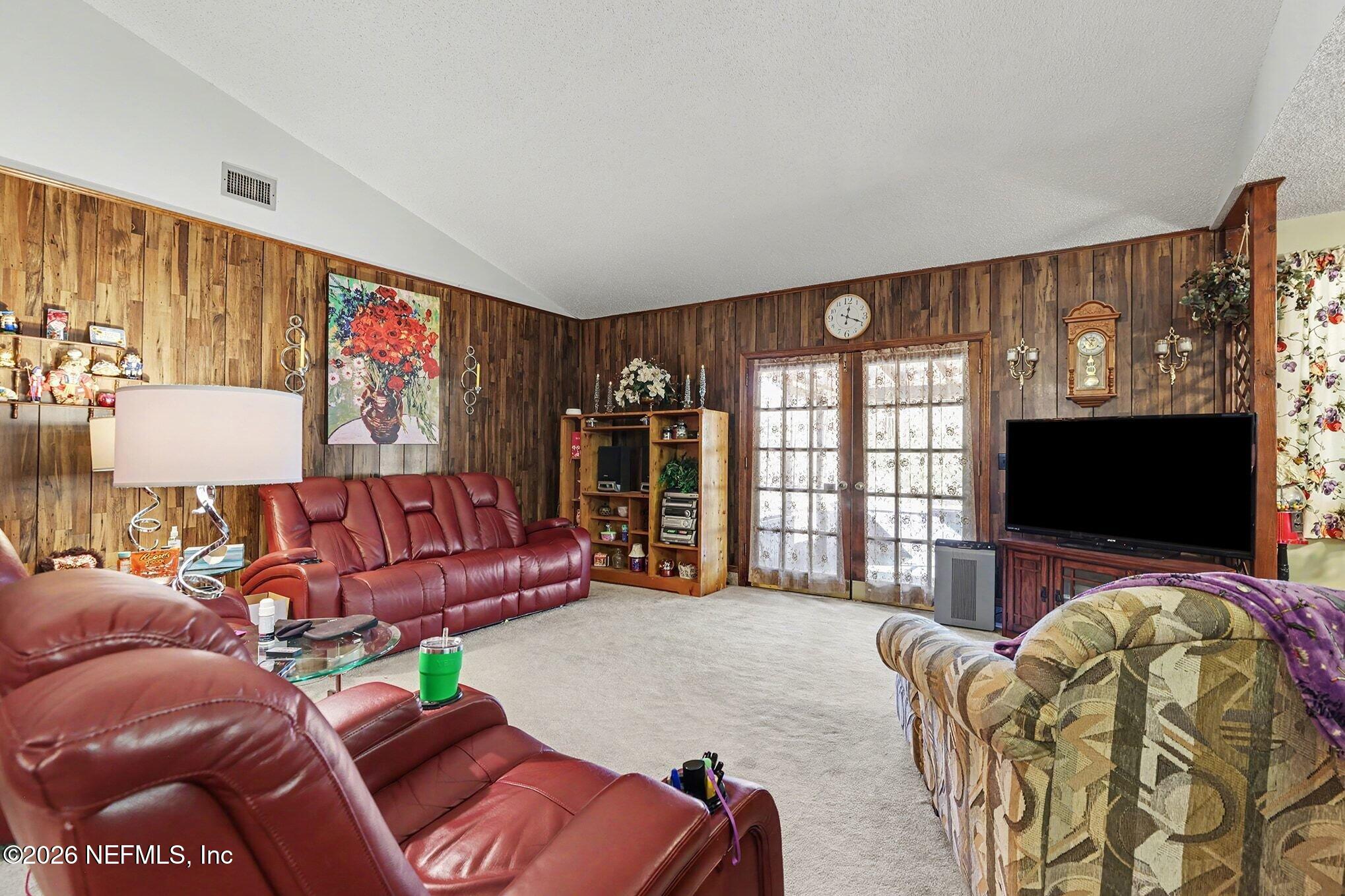2551 Ridgecrest Avenue Orange Park, FL 32065 - Photo 9 of 28 a living room with furniture and a flat screen tv