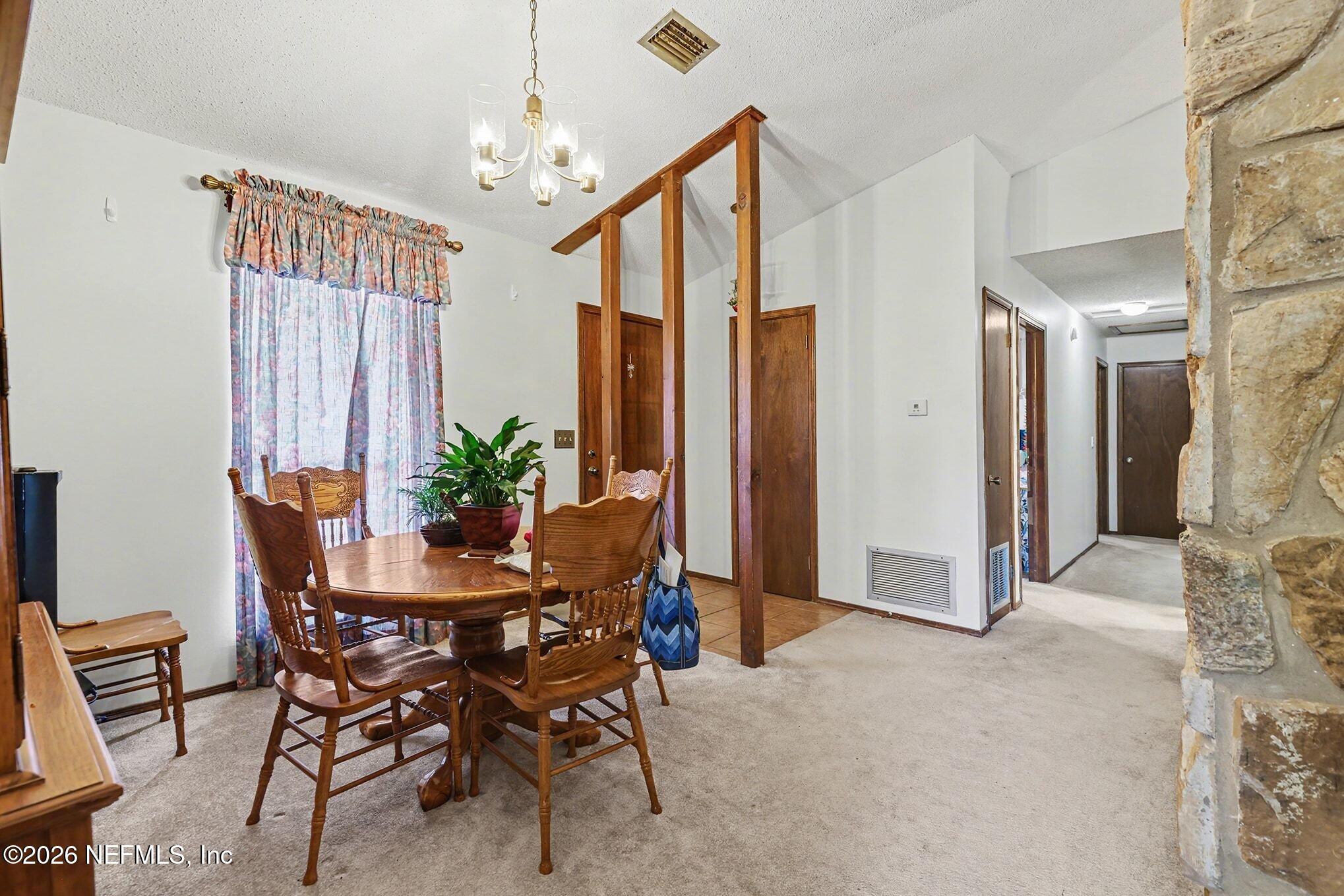 2551 Ridgecrest Avenue Orange Park, FL 32065 - Photo 10 of 28 a view of a dining room with furniture and a chandelier