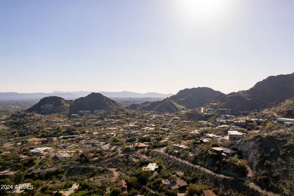 an aerial view of residential house and mountains