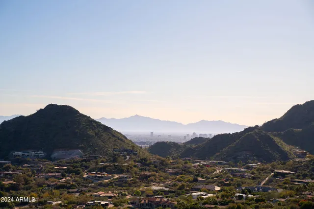 a view of a house with a mountain in the background