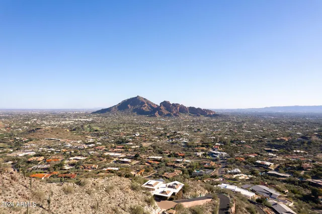 an aerial view of residential houses with city view