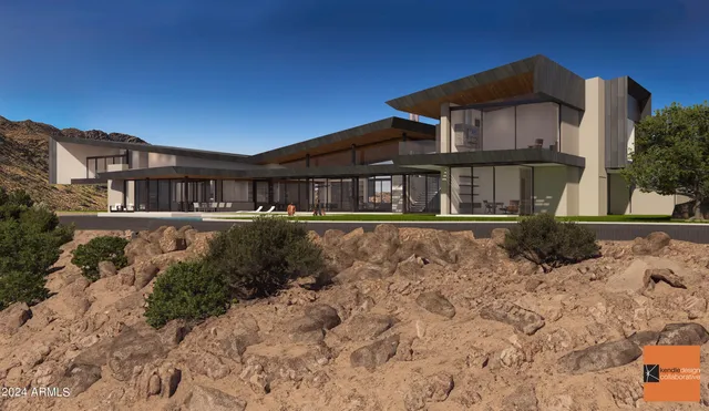 a front view of a house with large trees