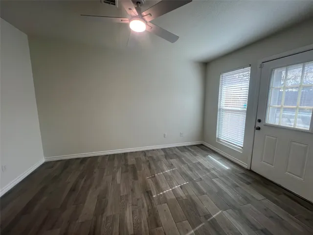 wooden floor in an empty room with a window