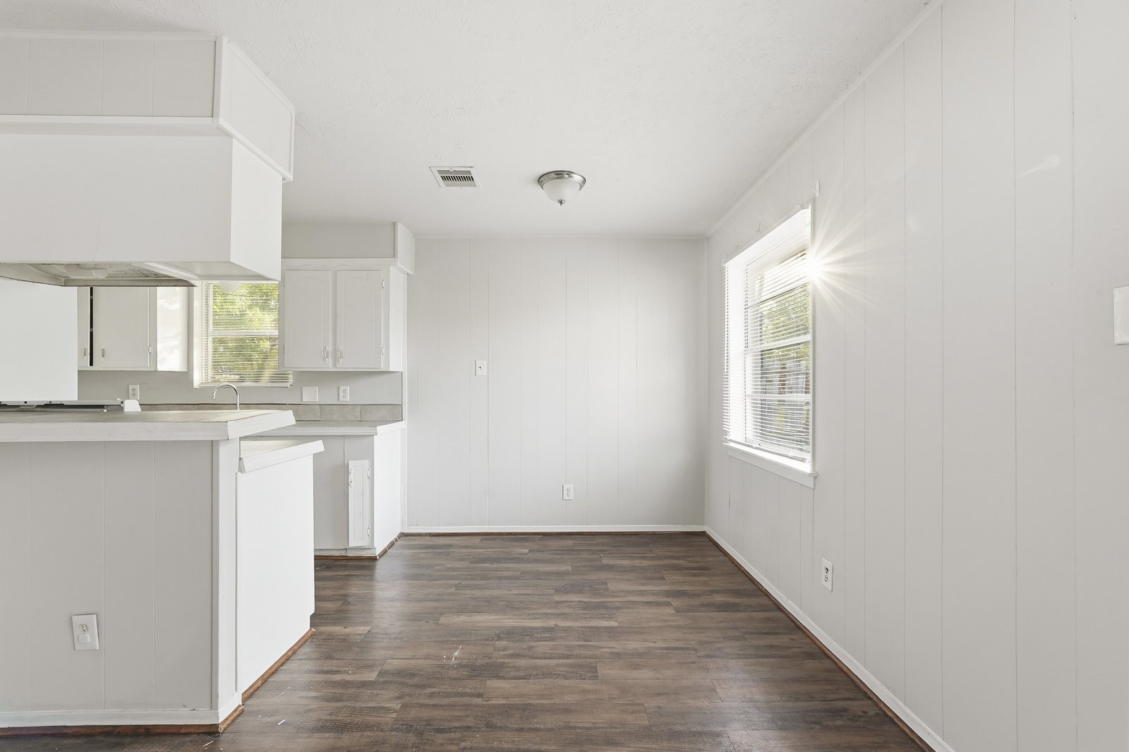3427 Prudence Drive Houston, TX 77045 - Photo 11 of 25 a view of a kitchen with granite countertop white cabinets and wooden floor
