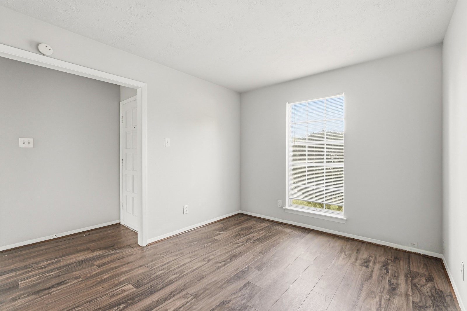 3427 Prudence Drive Houston, TX 77045 - Photo 12 of 25 an empty room with wooden floor and windows