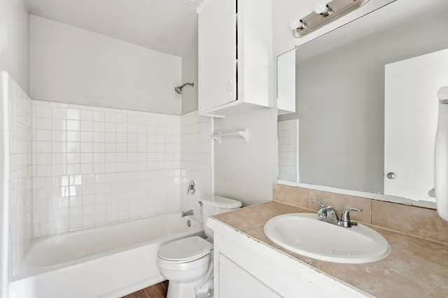 a bathroom with a sink toilet and shower