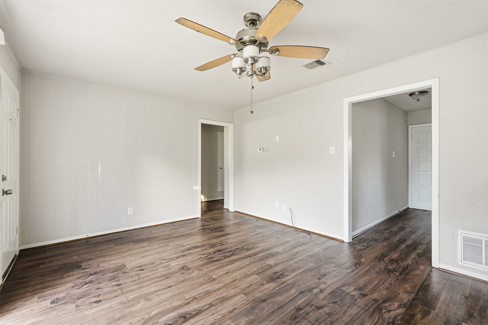 3427 Prudence Drive Houston, TX 77045 - Photo 14 of 25 an empty room with wooden floor fan and windows