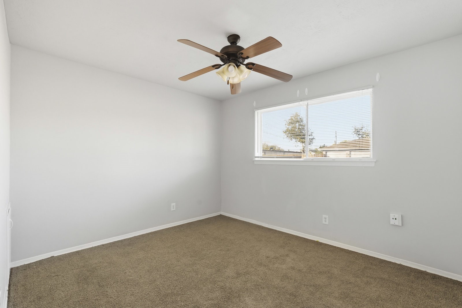 3427 Prudence Drive Houston, TX 77045 - Photo 16 of 25 an empty room with window and ceiling fan