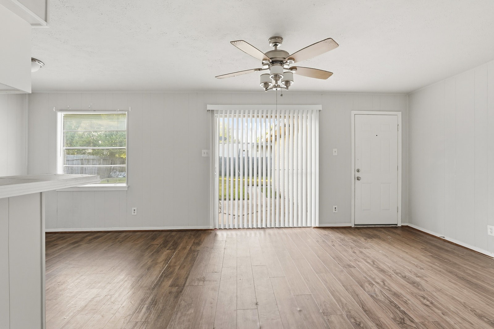 3427 Prudence Drive Houston, TX 77045 - Photo 4 of 25 a view of an empty room with wooden floor and a window