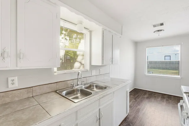 a kitchen with a sink cabinets and window