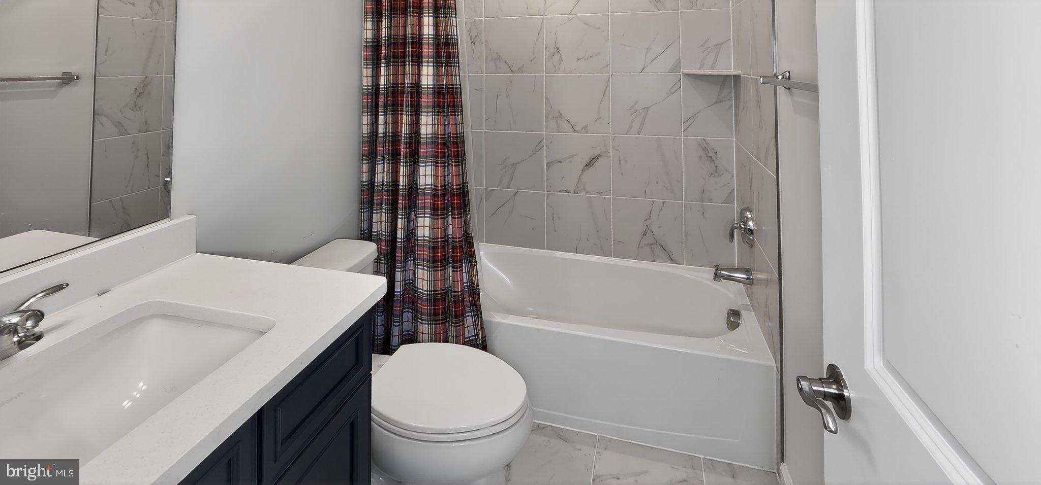 10570 Sally Ride Lane Lanham, MD 20706 - Photo 18 of 32 a bathroom with a sink a toilet and shower
