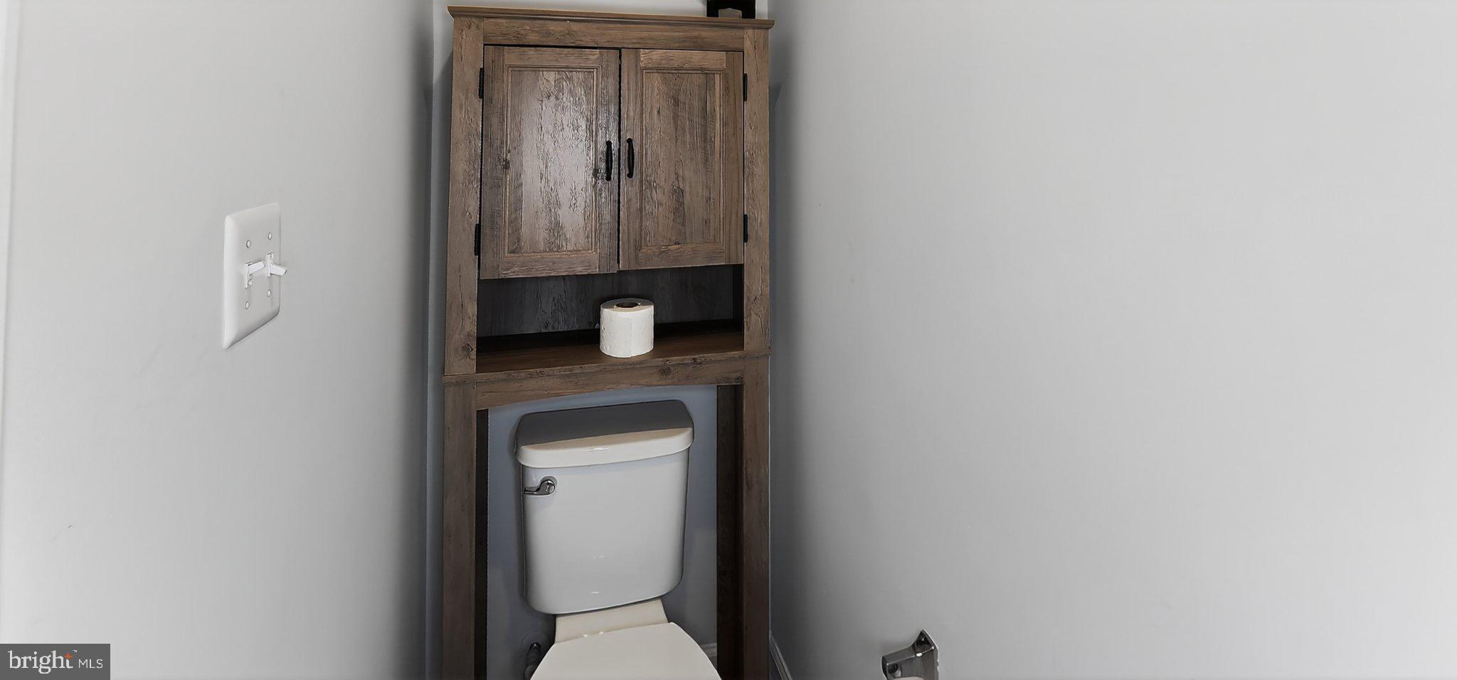 10570 Sally Ride Lane Lanham, MD 20706 - Photo 22 of 32 a close view of a bathroom with a toilet sink and mirror