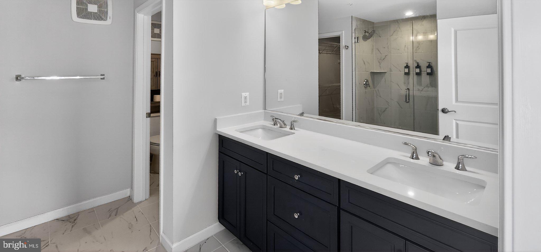 10570 Sally Ride Lane Lanham, MD 20706 - Photo 25 of 32 a bathroom with a double vanity sink mirror and double