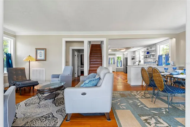 a living room with furniture and a potted plant