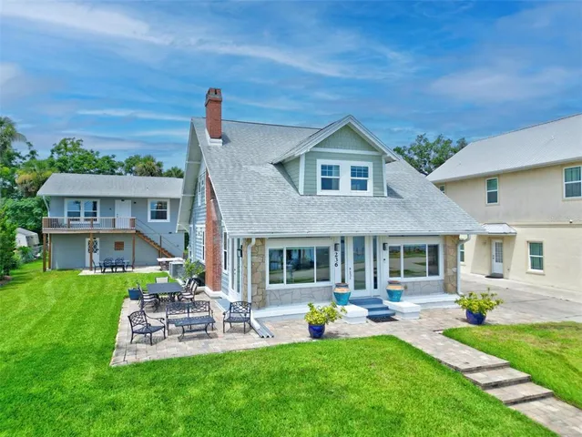 a large white kitchen with cabinets a sink and stainless steel appliances