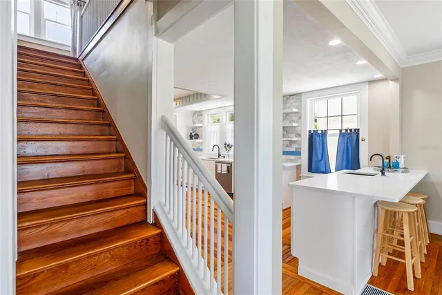 a bedroom with a bed and a large mirror on the dresser